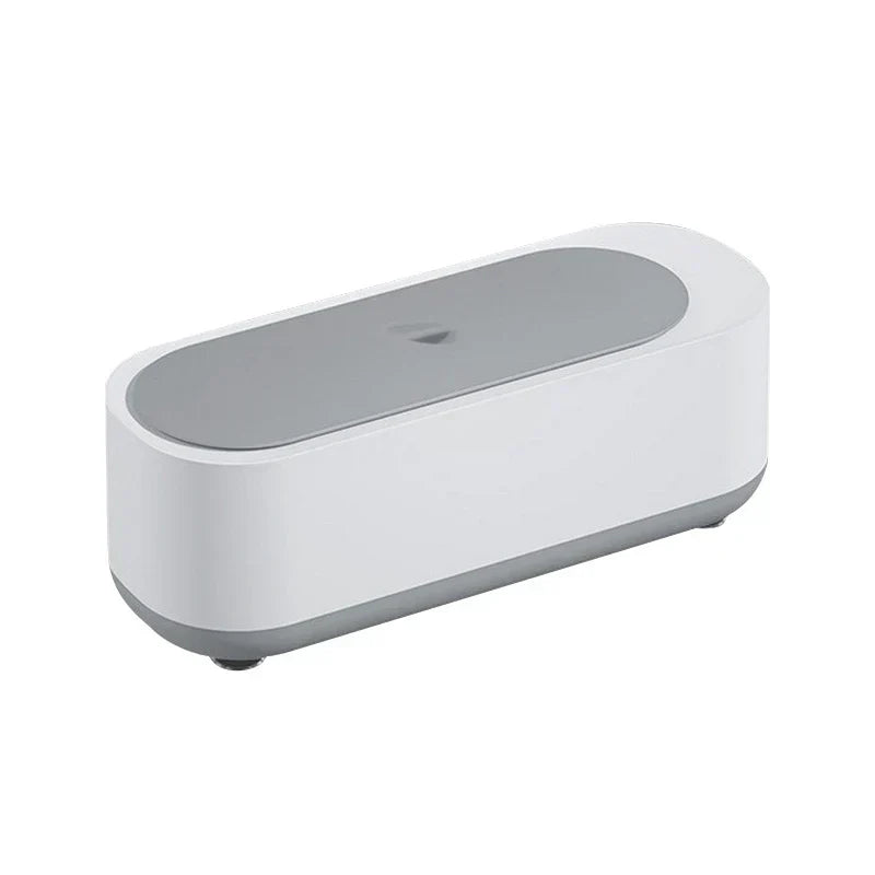 White and gray oval eyeglass cleaner machine with closed lid on a white background