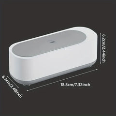 Dimensioned front view of a white and gray eyeglass cleaner machine on black background