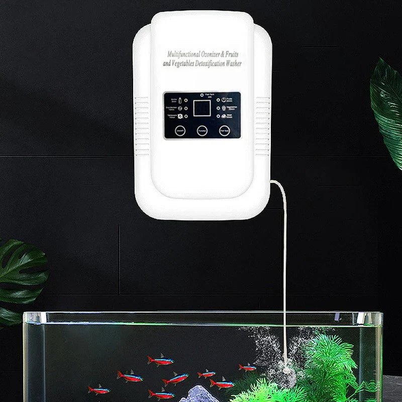 Ultrasonic Vegetable Fruit Washer - Unit mounted on dark tiled wall with connected tube running into a clear water tank, surrounded by decorative houseplant leaves