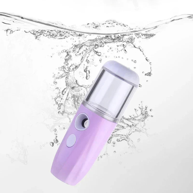 Nano Mist Facial Sprayer - Lavender handheld mist sprayer submerged in splashing clear water against a white background