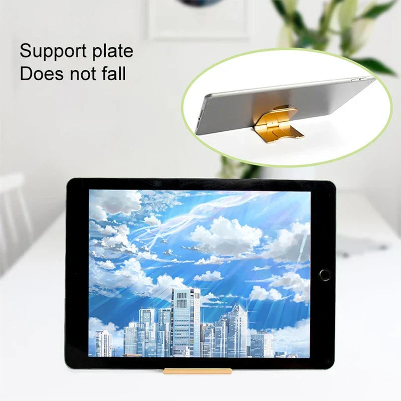 Cell Phone Holder - Black tablet held upright by a gold stand on a white surface, side view of the stand shown in a circular inset