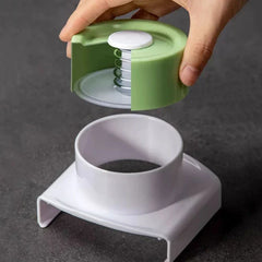 Mandoline - Cutaway view of the spring-loaded hand guard, separated from its base to reveal internal spring mechanism
