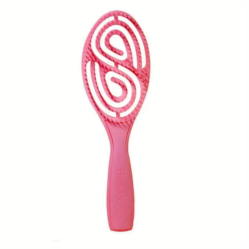 Paddle Hair Brush - Bright pink vented hair brush standing upright against a plain white background