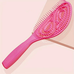 Paddle Hair Brush - Pink hollow hair brush angled to display its bristle side and curved handle