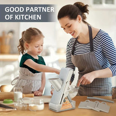 Mandoline Slicer Chopper - Woman and young child using the slicer at a kitchen counter, with blades and a cleaning brush placed nearby