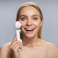 Blackhead Remover Vacuum - Person holding the handheld skincare device next to their cheek