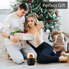 Aroma Diffuser Humidifier - Black volcano-style humidifier on a wood floor in front of a couple opening gifts beside a decorated Christmas tree, with 'Perfect Gift' text