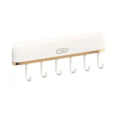 Pot Lid Organizer - White ribbed wall-mounted storage rack with gold trim and six hanging hooks