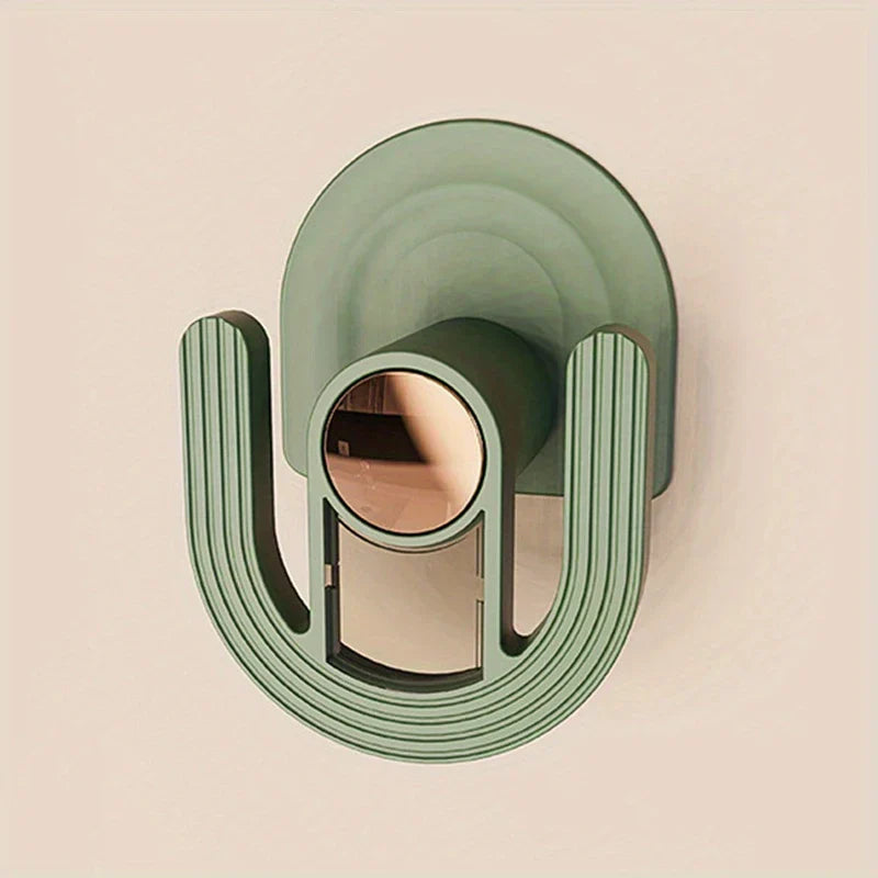 Slipper Rack Organizer - Close-up of a green U-shaped adhesive wall hook with rose gold center accent on a plain light wall