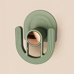 Slipper Rack Organizer - Close-up of a green U-shaped adhesive wall hook with rose gold center accent on a plain light wall