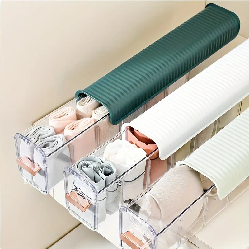 Sock Underwear Organizer Box - Three stacked clear plastic divided storage organizers with ribbed colored tops holding rolled socks and undergarments in a drawer.