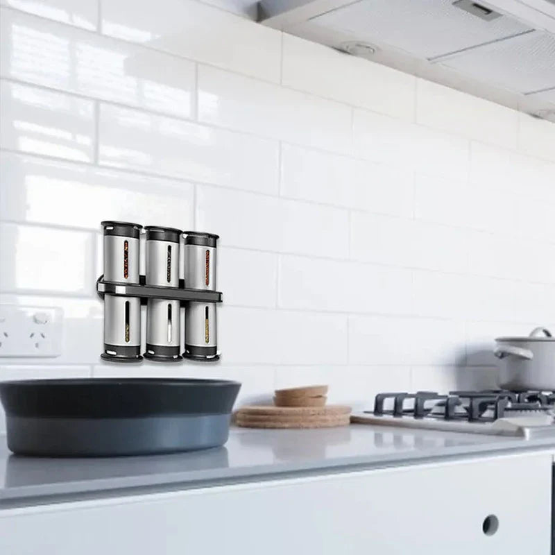 Magnetic Spice Rack Shelf - Wall-mounted spice rack holding six canisters, attached to white tile kitchen wall above a counter