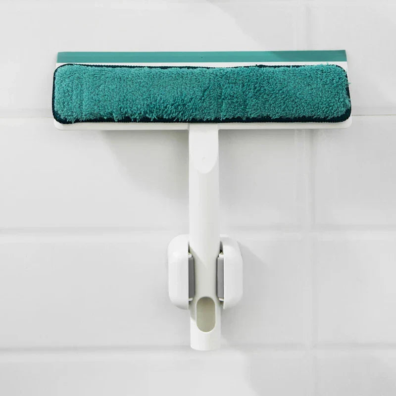 Broom Holder - White wall-mounted holder securing a window squeegee on a white tiled wall