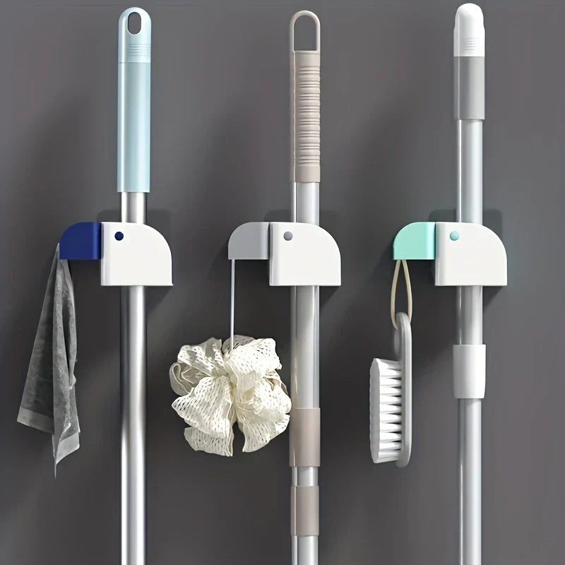 Close-up of the secure grip clips on the mop and broom holder wall mount