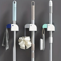 Close-up of the secure grip clips on the mop and broom holder wall mount
