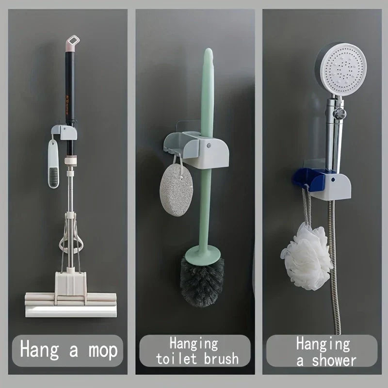 Mop And Broom Holder - Three side-by-side wall holders mounted on a wall, holding a mop, toilet brush, and handheld shower with hanging accessories respectively
