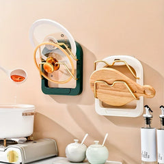 Pot Lid Organizer - Two mounted racks installed on a kitchen wall holding pot lids and a wooden cutting board