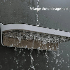 Wall Mounted Shelf - Shelf mounted against a dark wet surface with water draining through enlarged holes.