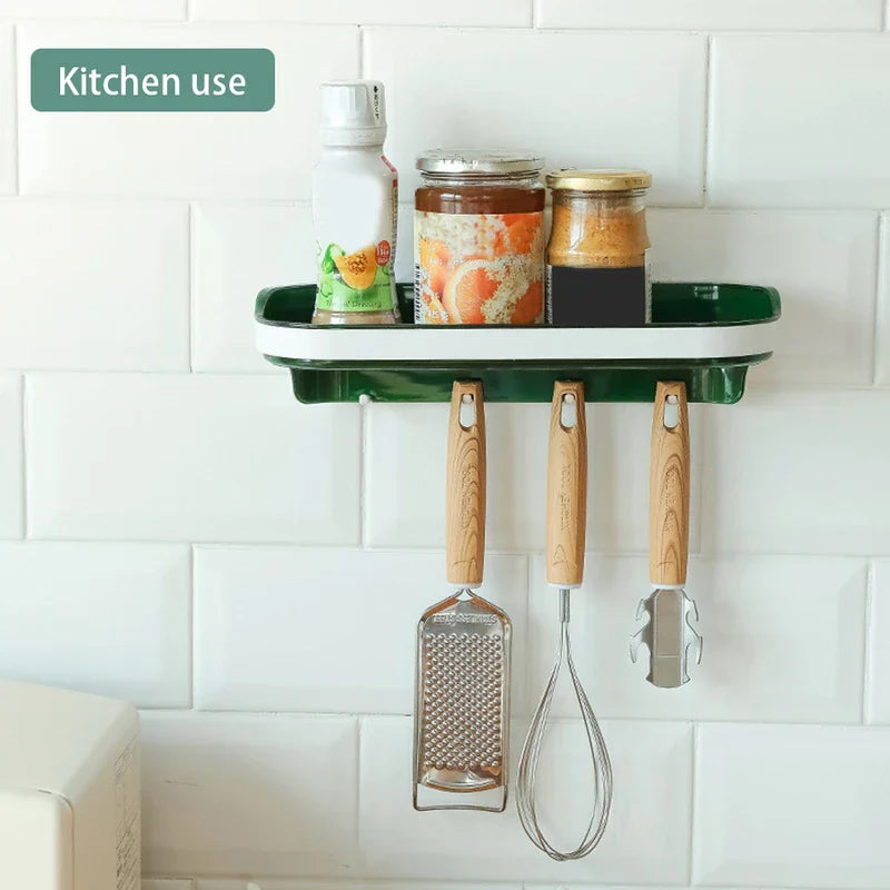 Wall Mounted Shelf - Green and white wall-mounted shelf holding three jars, with three kitchen utensils hanging from its hooks, against a white tiled wall.