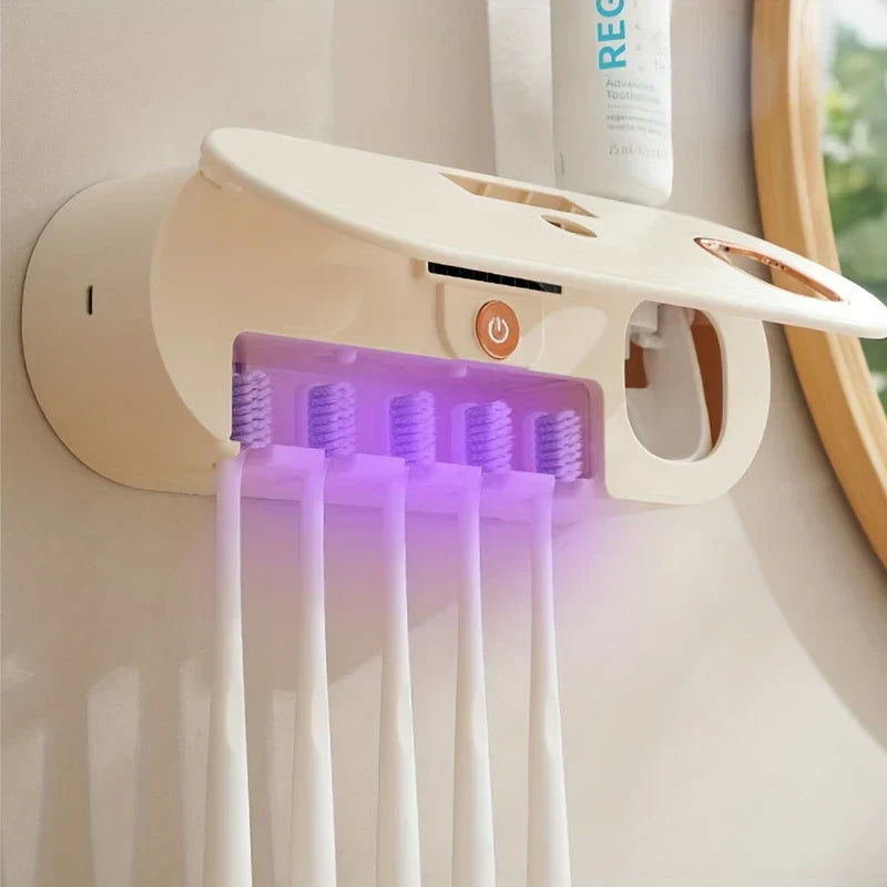 Uv Toothbrush Sanitizer - Cream-colored wall-mounted oral care device with open cover holding five manual toothbrushes under purple sanitizing light