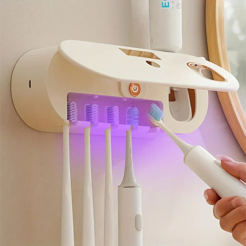 Uv Toothbrush Sanitizer - Wall-mounted toothbrush holder with open UV compartment, hand inserting an electric toothbrush, purple light inside