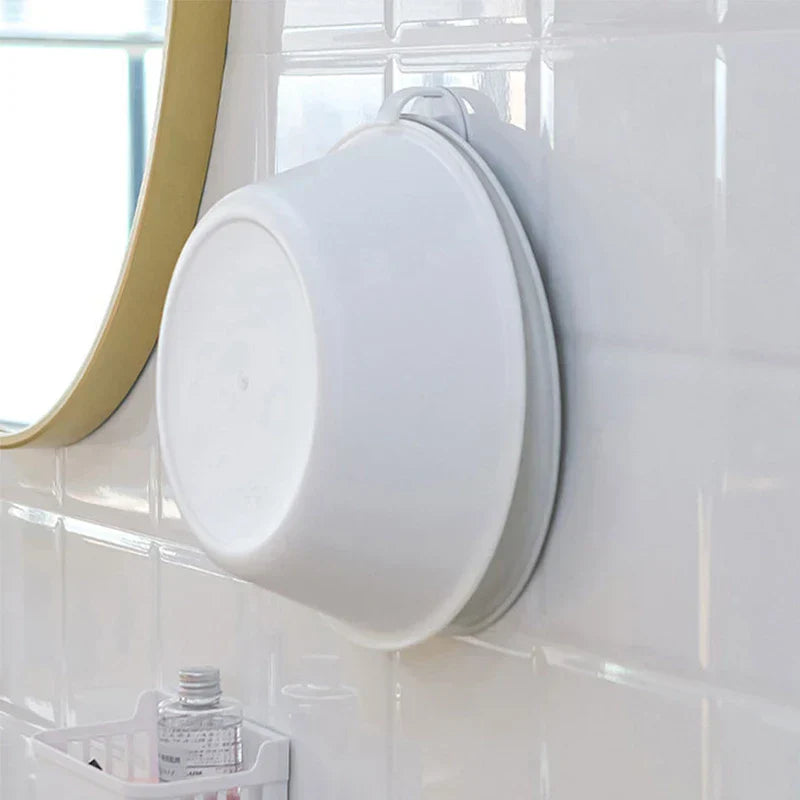 White wash basin storage rack mounted on tiled bathroom wall holding stacked basins