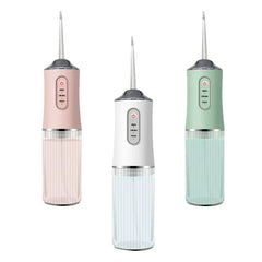 Water Flosser - Three portable oral irrigators in blush pink, white, and sage green, each with clear ribbed reservoir and control panel