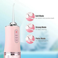 Close-up of pink portable water flosser with three mode descriptions and usage diagram callouts