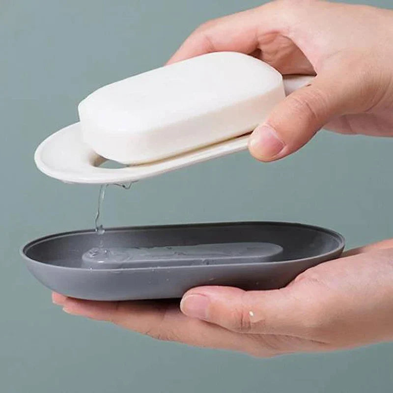 Draining soap dish with water runoff on shower ledge