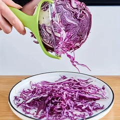 Vegetable Slicer - Green handled tool shredding purple cabbage into thin strips over a plate