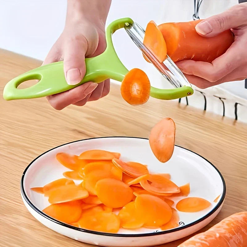 Vegetable Slicer - Hands using the green peeler to slice a carrot over a white plate with black rim, holding peeled carrot slices below.