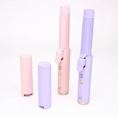 Pastel pink and purple cordless hair curlers with matching protective caps on white background
