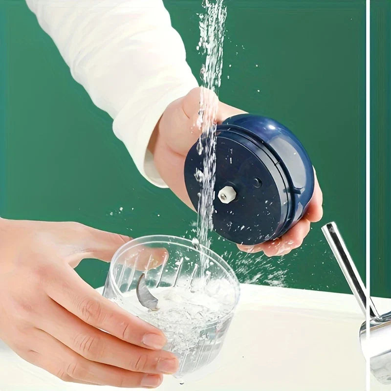 Garlic Mincer - Two hands rinsing the separated chopper motor top and clear blade cup under running tap water.