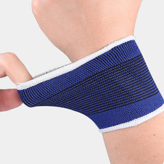 Wrist Brace - Close-up of a hand pulling the edge of a blue elastic wrist support with white trim on skin, showing its stretch
