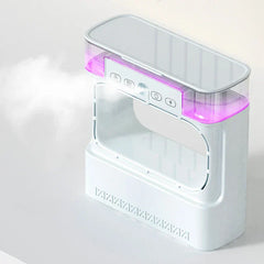 Tower Fan - Same device shown at an angle, mist exiting left side, purple light lit in its top water tank