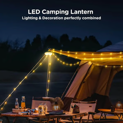 Camping String Lights - LED camping lantern hanging from a tent pole with attached string lights illuminating a camping table at night