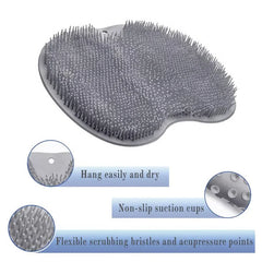 Gray heart-shaped silicone shower foot scrubber mat with callouts for hanging hole, suction cups, and bristles