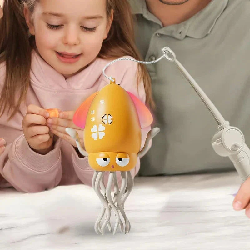 Dancing Octopus Musical Toy - Child watching the yellow toy dance on a flat surface as an adult holds the attached pull wand