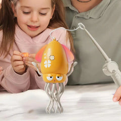 Dancing Octopus Musical Toy - Child watching the yellow toy dance on a flat surface as an adult holds the attached pull wand