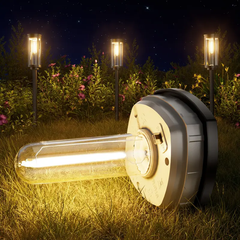 Solar Pathway Lights - A lit solar path light lies on grass at night, with three standing lit path lights behind it among foliage.