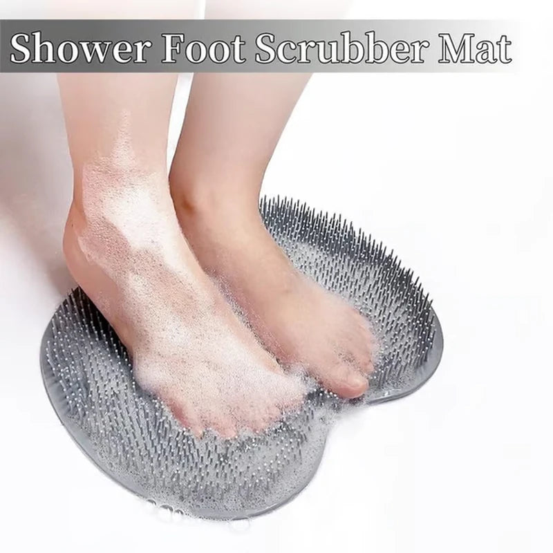 Feet covered in soap suds standing on a foamy silicone shower foot scrubber mat in a shower setting