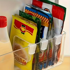 Adjustable Fridge Dividers - Clear plastic fridge shelf dividers organizing assorted sauce packets in a clear storage bin