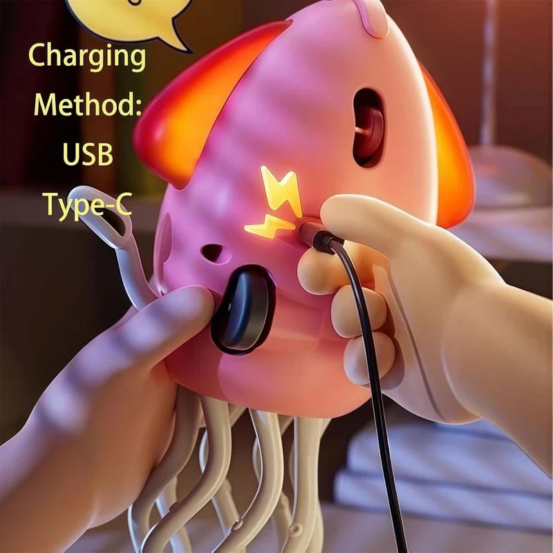 Dancing Octopus Musical Toy - Hands hold a pink squid toy while plugging in a USB Type-C charging cable to its side port.