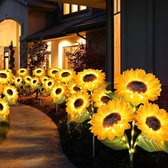 Sunflower Garden Lights - Lit decorative flower-shaped lights lining a curved residential walkway at night