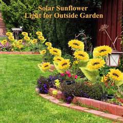 Sunflower Garden Lights - Solar sunflower stake lights placed in a garden border next to a green lawn