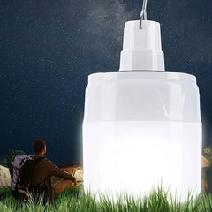 Outdoor Tent Emergency Light Usb Charging Lantern - Illuminated hanging light positioned in tall grass, with a seated camper and tent visible under a starry night sky