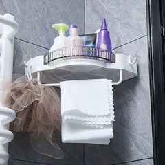Floating Wall Shelf - White corner shower caddy mounted on tile wall, holding body care bottles, with towel and bath loofah hanging below