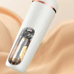 Cutaway view of white electric foot callus remover with visible internal components, resting on beige fabric