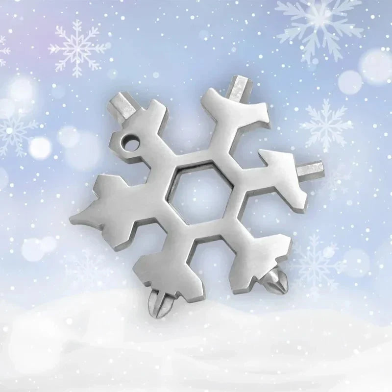 Silver snowflake multi-tool with screwdriver and wrench heads on snowy background