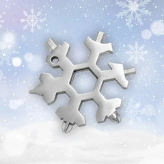 Silver snowflake multi-tool with screwdriver and wrench heads on snowy background